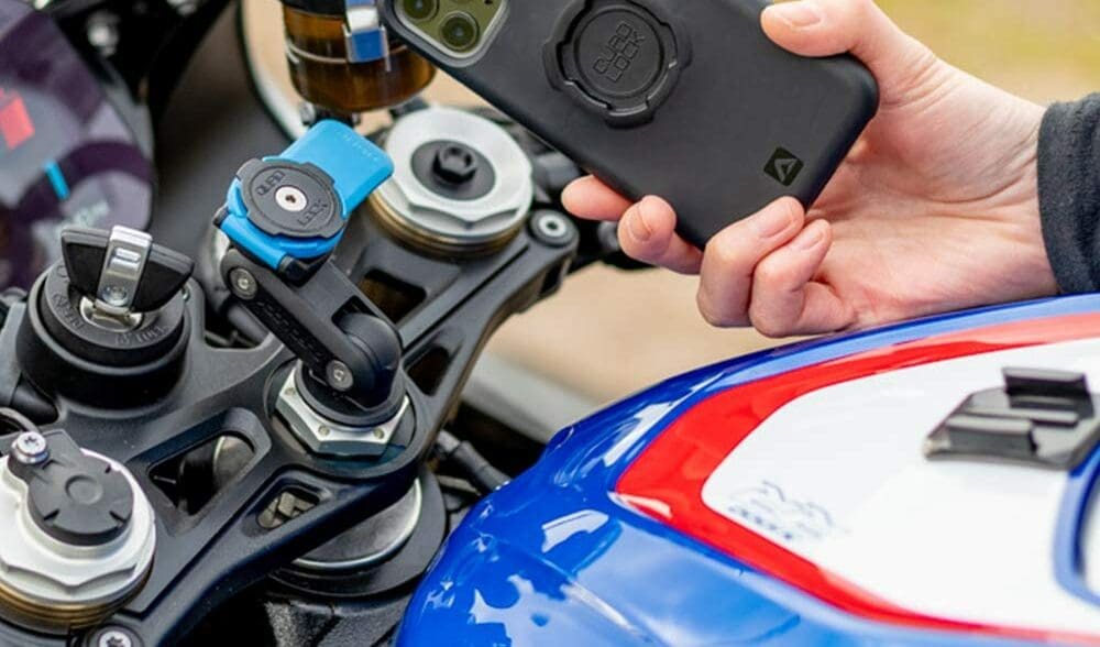 A rider on a BMW motorcycle, trying out the Quad Lock phone mount