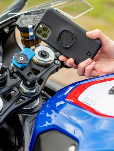 A rider on a BMW motorcycle, trying out the Quad Lock phone mount
