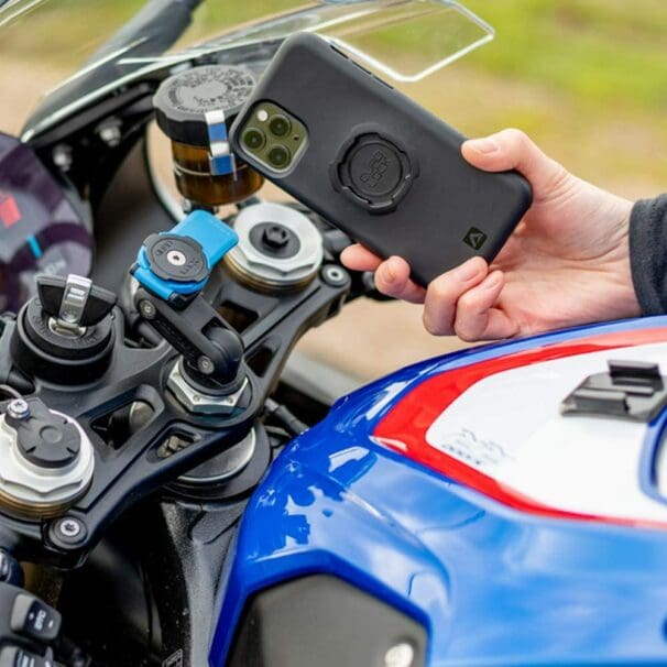 A rider on a BMW motorcycle, trying out the Quad Lock phone mount