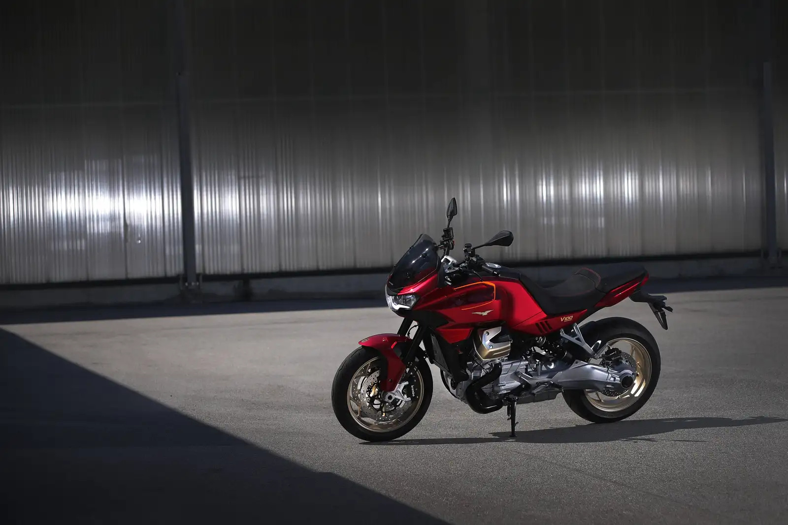 A side view of the 2022 Moto Guzzi V100 Mandello with metalwork as the backspace