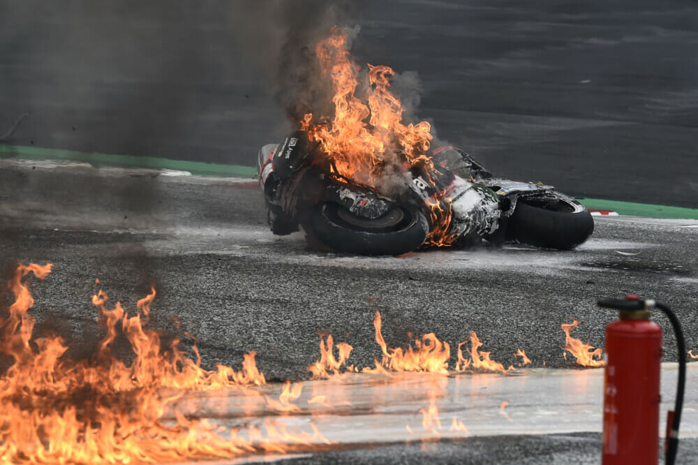 A view of a bike on fire after a crash at the MotoGP races