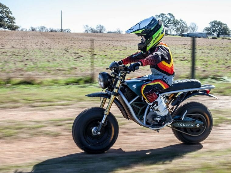 A view of a small child trying out the Runt - an all-terrain electric motorcycle made available to USA and Latina America from Volcon Powersports this summer 2021