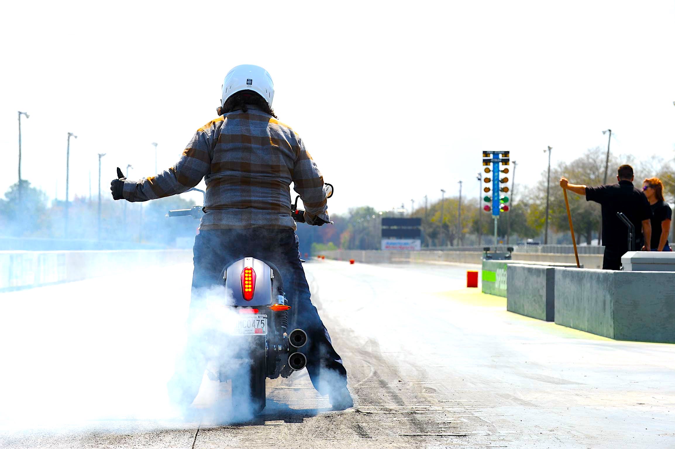 A view of a rider about to launch down a drag strip