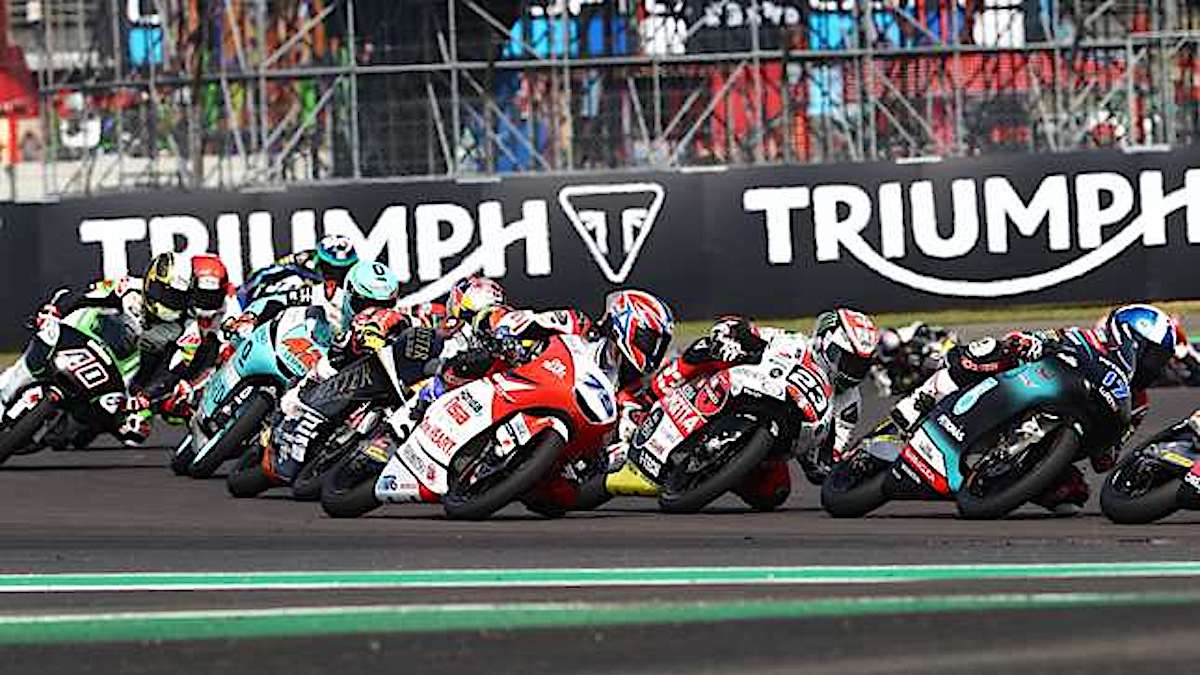 a lineup of Moto3 machines on a sharp turn.