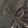 Closeup showing open upper zippered thigh pockets