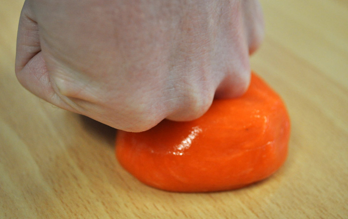 A close-up of a hand punching D30's non-Newtonian goo