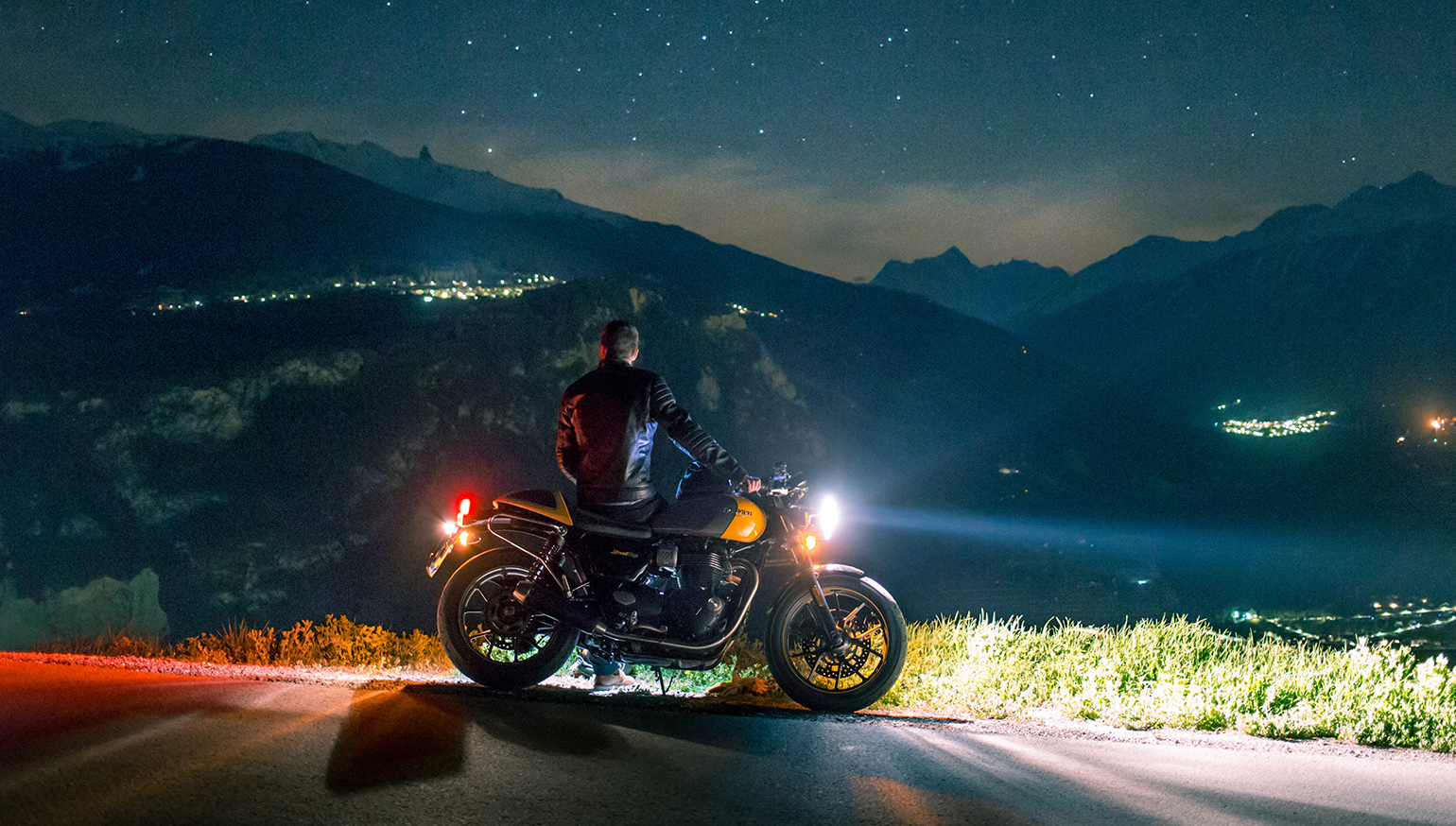 A night picture of a rider with a motorcycle