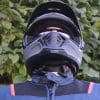 A frontal view of the Scorpion EXO HX1 Helmet with a view of the chin strap and chin curtain