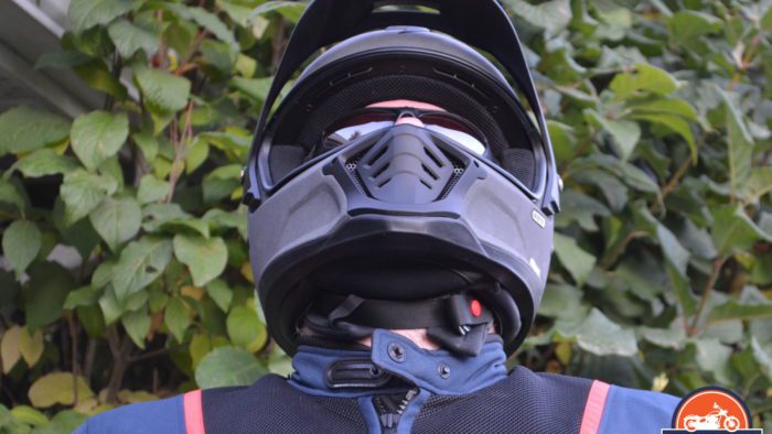 A frontal view of the Scorpion EXO HX1 Helmet with a view of the chin strap and chin curtain