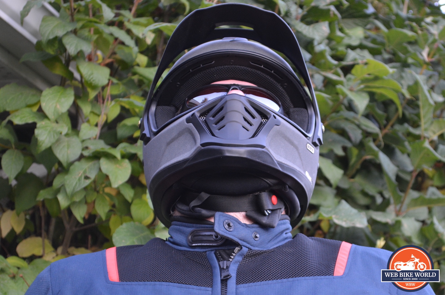 A frontal view of the Scorpion EXO HX1 Helmet with a view of the chin strap and chin curtain