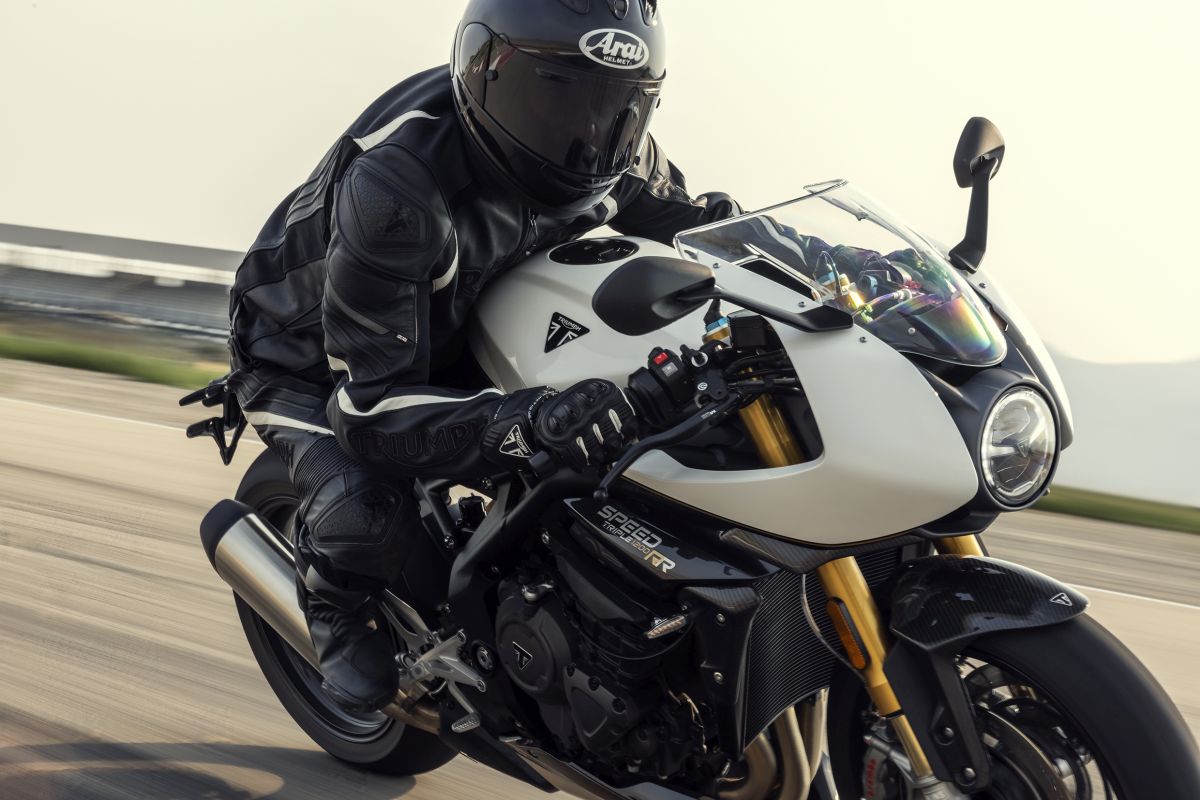 A side view of a rider enjoying the 2022 Triumph Speed Triple 1200 RR