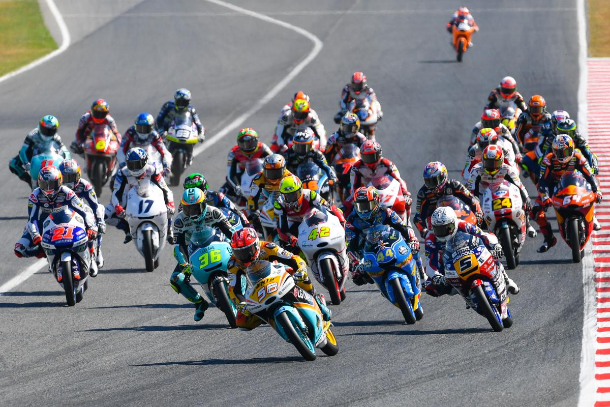 a lineup of Moto3 machines on a sharp turn. 