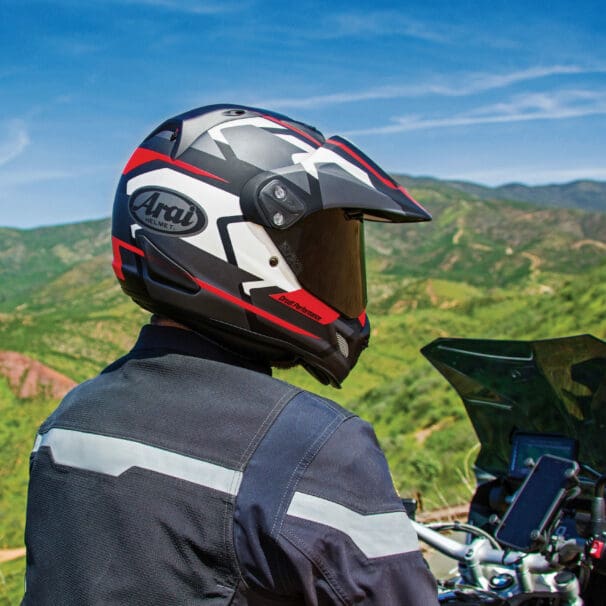 A view of a rider trying out the Arai XD4, with a rugged topography in the background