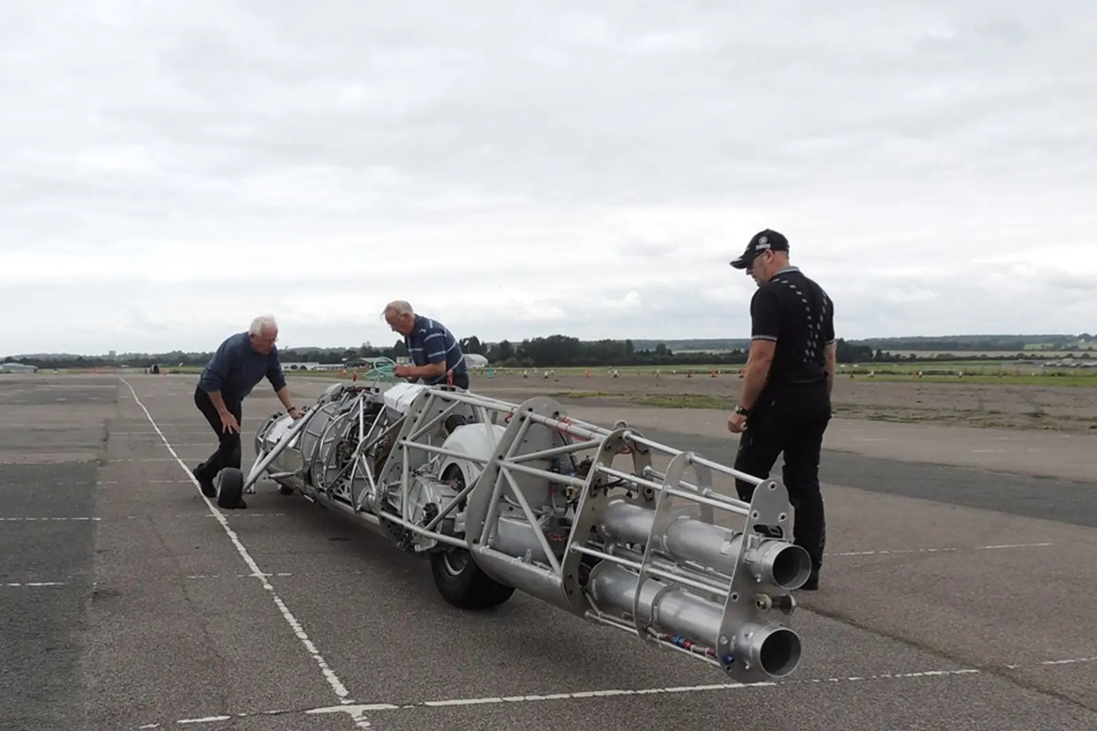 former GP and TT sidecar racer Alex Macfadzean, as well as British Superbike team owner Bernie Toleman with Guy Martin, checking the machine over