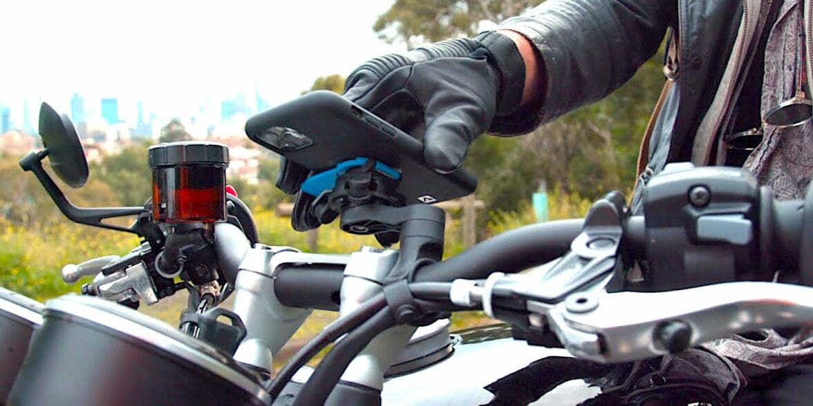 A view of a rider trying out the QuadLock phone mount with the optional vibration Damper