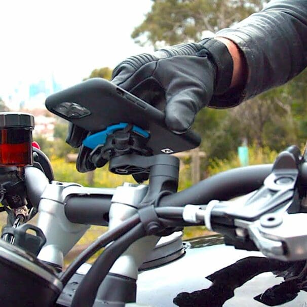 A view of a rider trying out the QuadLock phone mount with the optional vibration Damper