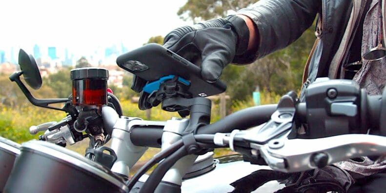 A view of a rider trying out the QuadLock phone mount with the optional vibration Damper