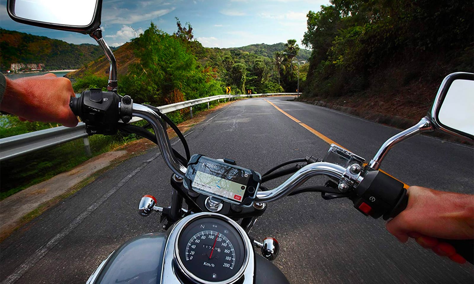 A view of a motorcycle phone mount being attached directly to the handlebars- a danger to the phone, should it be newer than 2015. 