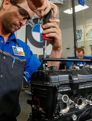 A worker wrenching on a BMW Bike at the Universal Technical Institute (UTI)