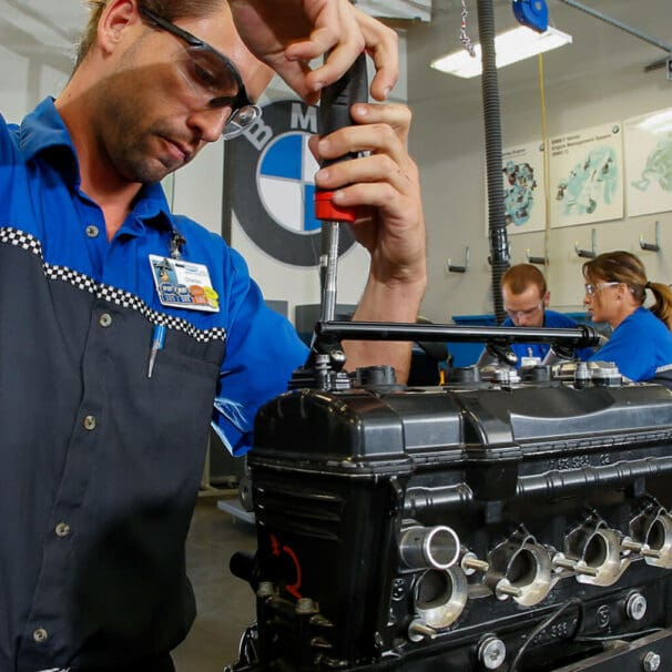 A worker wrenching on a BMW Bike at the Universal Technical Institute (UTI)