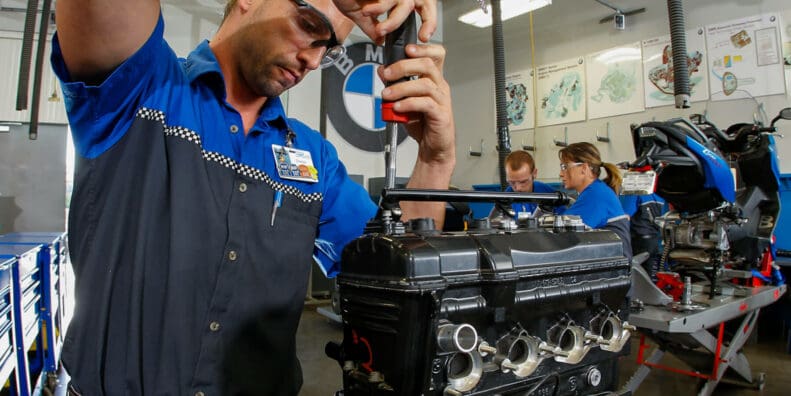 A worker wrenching on a BMW Bike at the Universal Technical Institute (UTI)