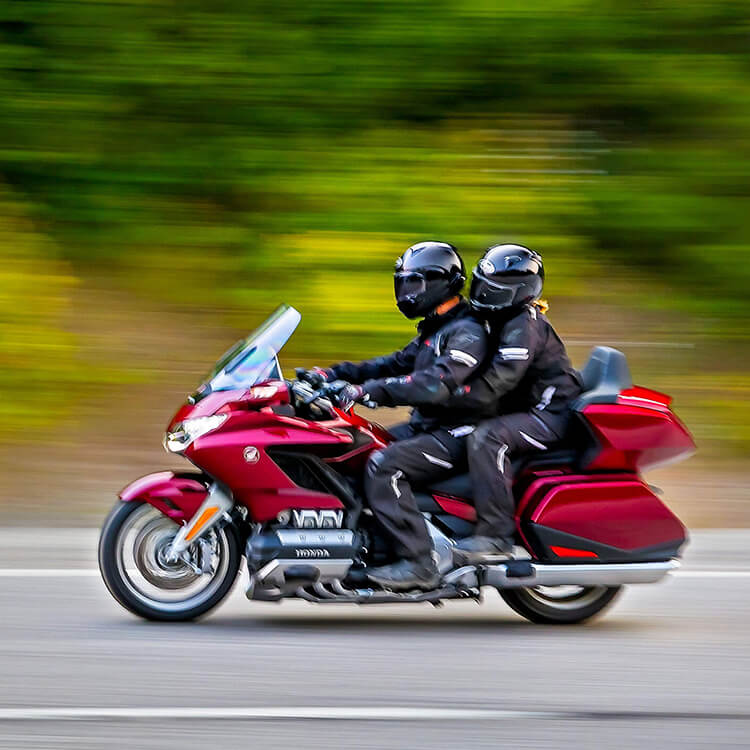 A side view of two riders on a Honda GoldWing