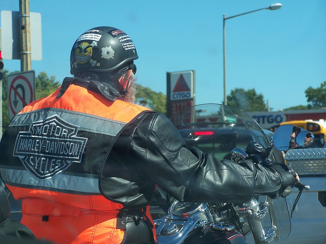 Rider on motorcycle wearing Harley vest