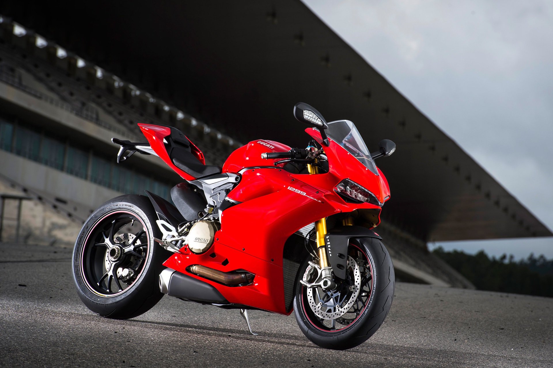 Red 2015 Ducati 1299 Panigale S parked near stadium stands