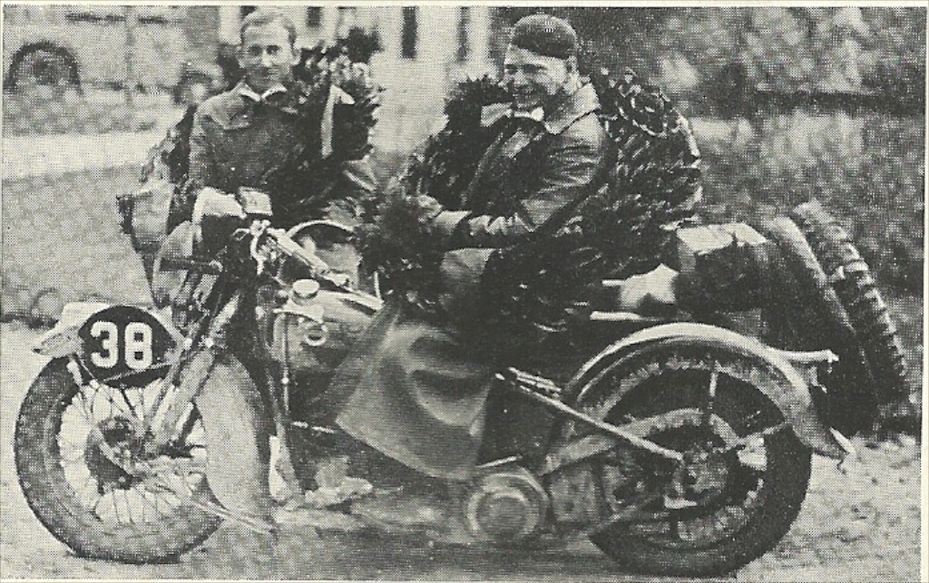 A side view of a rider aboard an old Harley-Davidson racer motorcycle