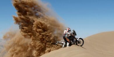 A rider racing in an enduro event similar to the 2021 Morocco Rally or the Dakar Rally