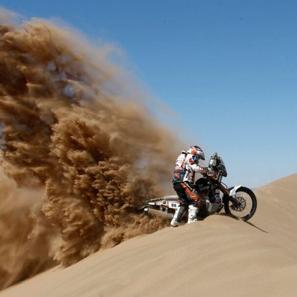 A rider racing in an enduro event similar to the 2021 Morocco Rally or the Dakar Rally