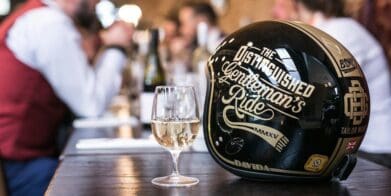 A view of a Distinguished Gentleman's Ride helmet with a glass of champagne