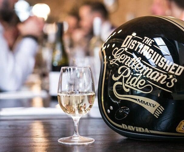 A view of a Distinguished Gentleman's Ride helmet with a glass of champagne