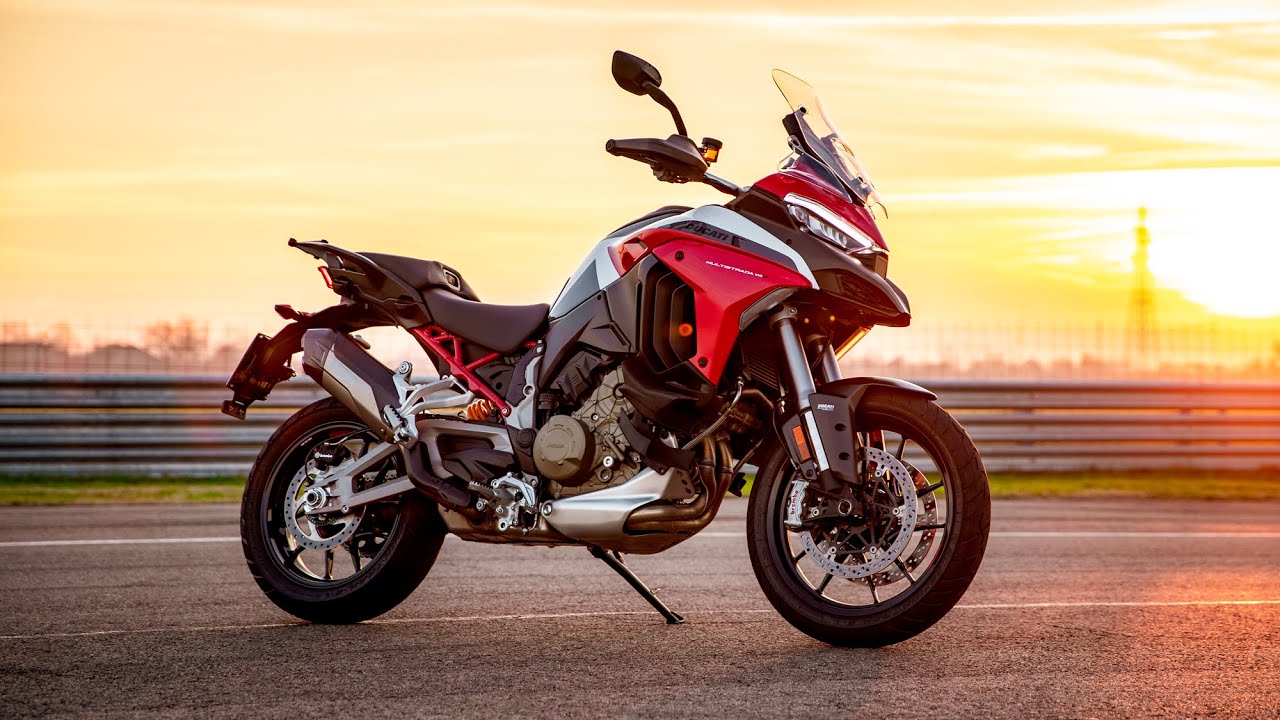 A static shot of the Ducatil Multistrada V4 on a track as the sun sets in the background with a golden hue