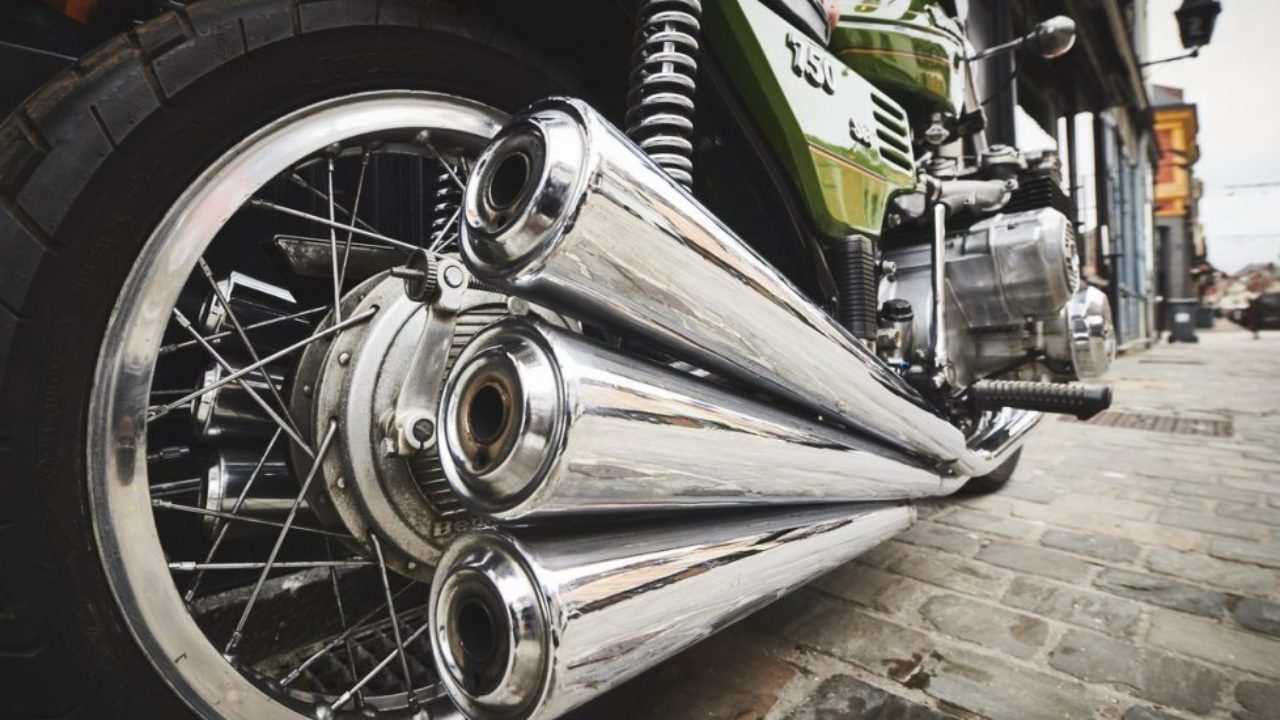 Close-up of three motorcycle exhaust pipes on a Benelli Sei 750