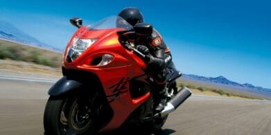 Rider on red 2008 Suzuki Hayabusa speeding down road