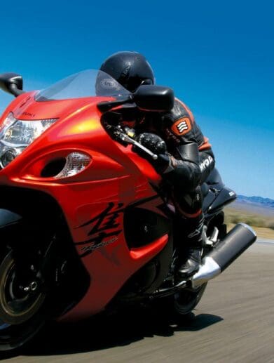 Rider on red 2008 Suzuki Hayabusa speeding down road