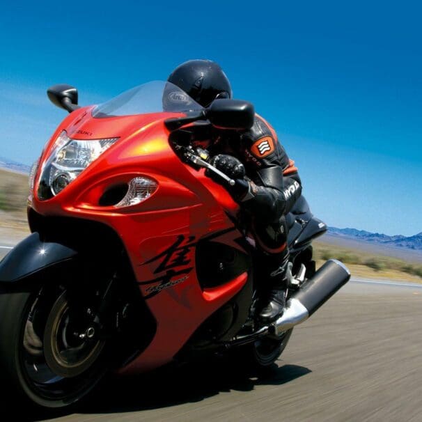 Rider on red 2008 Suzuki Hayabusa speeding down road