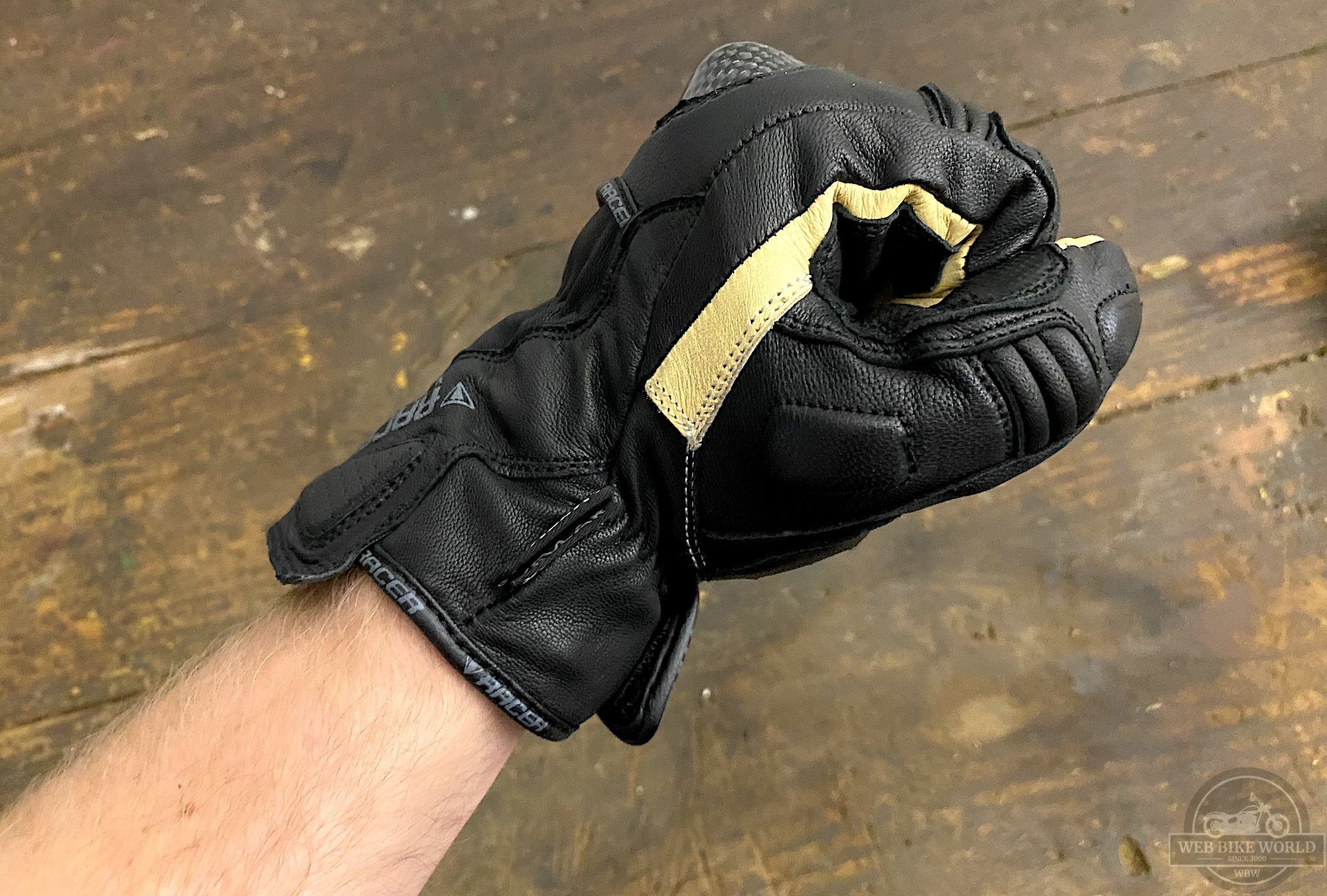 A closed fist while wearing the MultiTop Short gloves showing off the yellow kangaroo palm leather