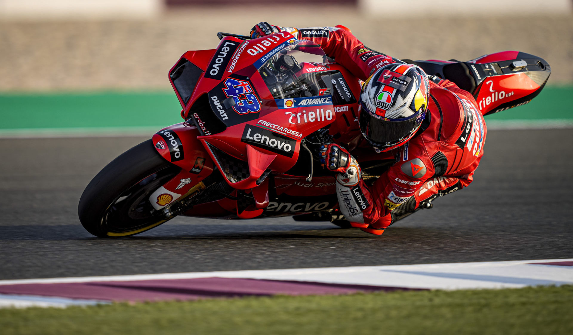 A view of a member of Ducati's Pramac Racing team leaning into the twisties at the track