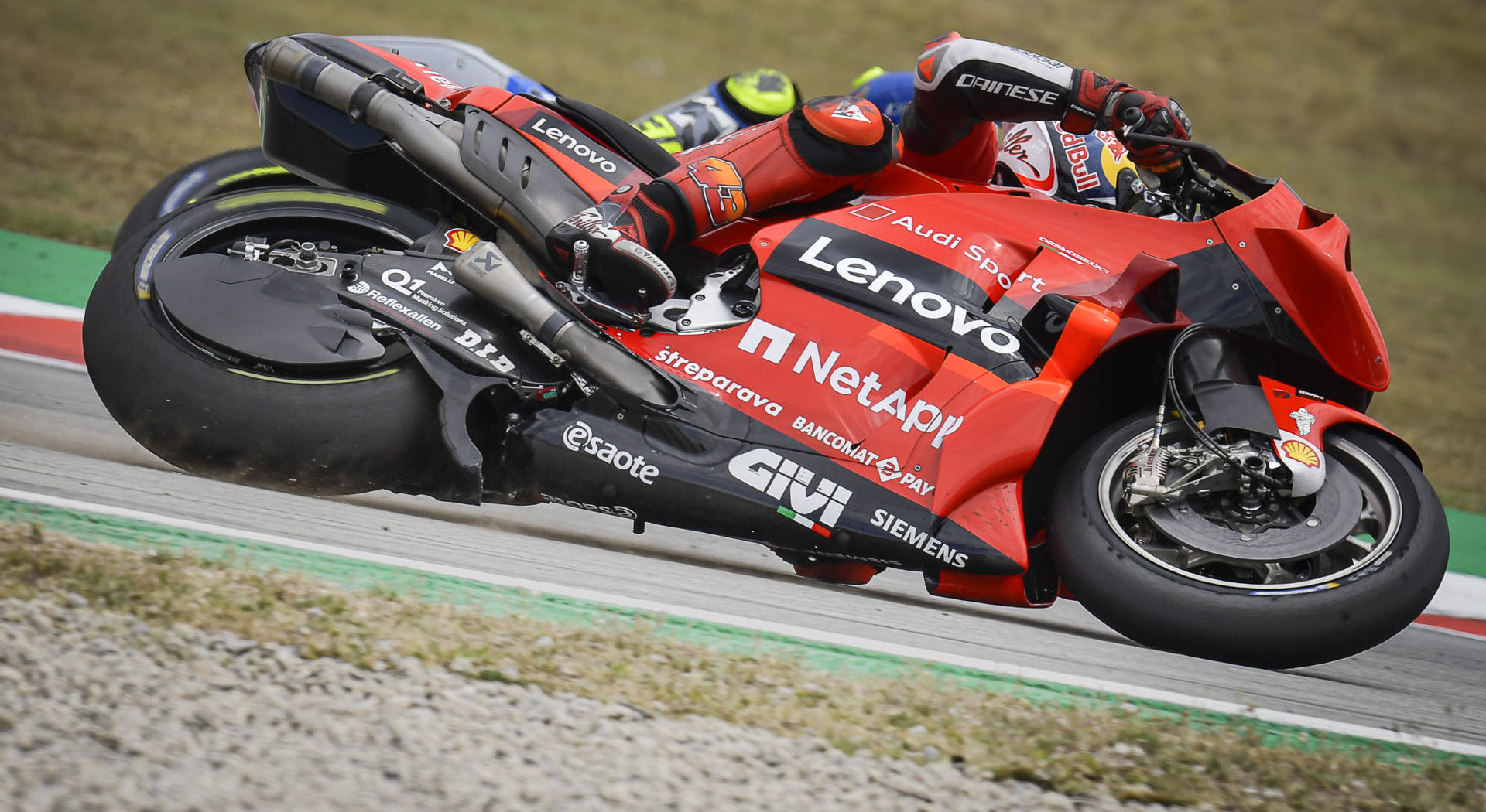 A view of a member of Ducati's Pramac Racing team leaning into the twisties at the track