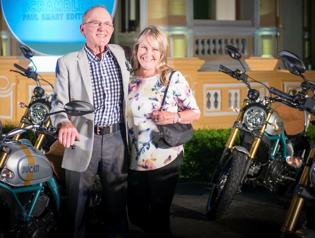 Paul Smart with his wife, discussing his history in motorcycle racing