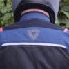 A view from the back of the Rev’It Tornado 3 Mesh Jacket, including bright striking colors in inorganic shapes