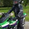 Man wearing Richa Airstorm WP Jacket while sitting on green Kawasaki motorcycle