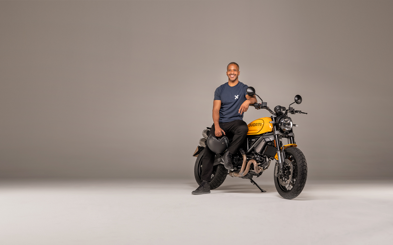 A view of a model astride the Ducati Scrambler 1100 Tribute PRO, as a result of the Ducati World Premiere; Mark Your Roots