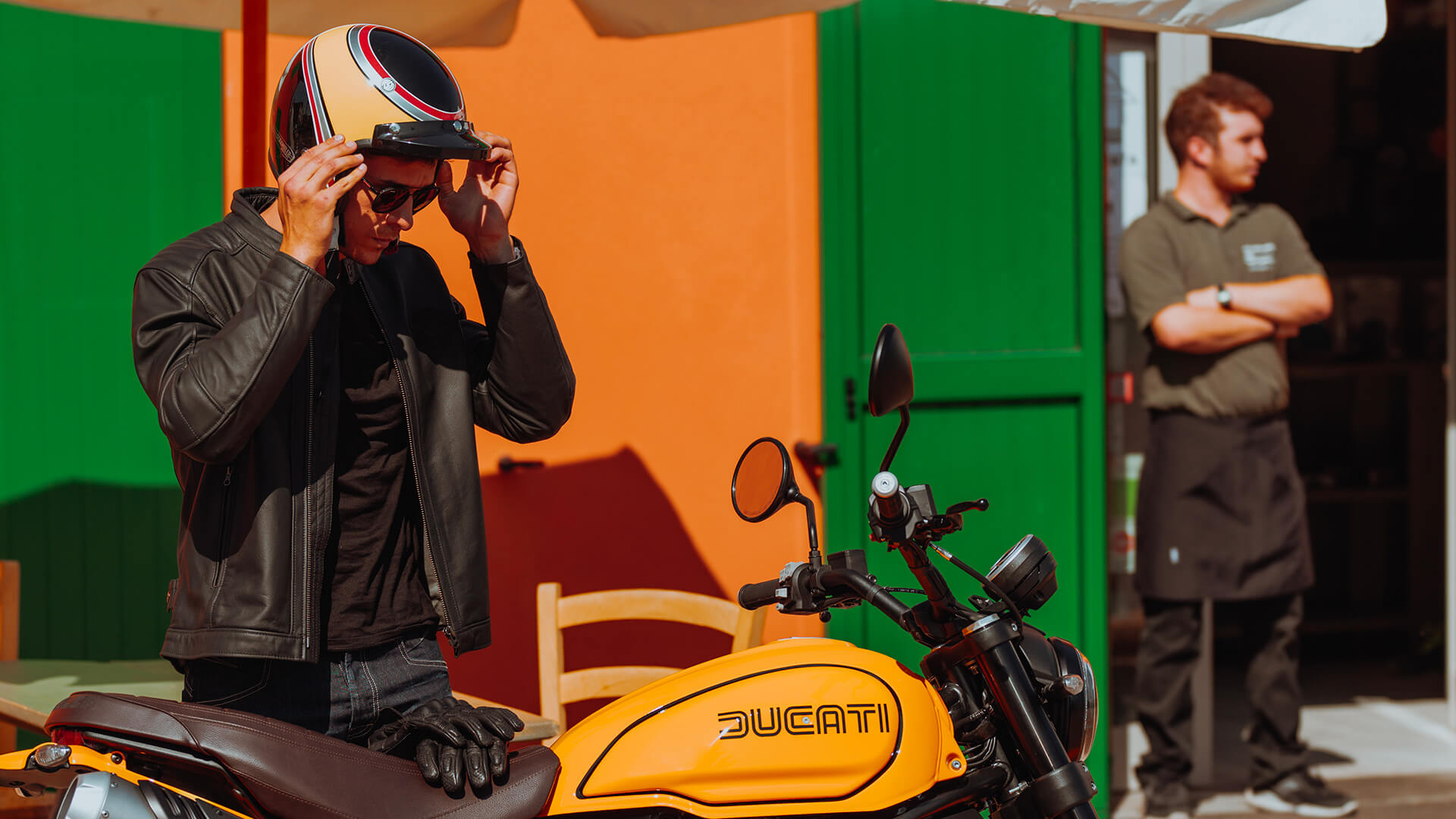 A view of a model getting ready to ride a Ducati Scrambler 1100 Tribute PRO, as a result of the Ducati World Premiere; Mark Your Roots