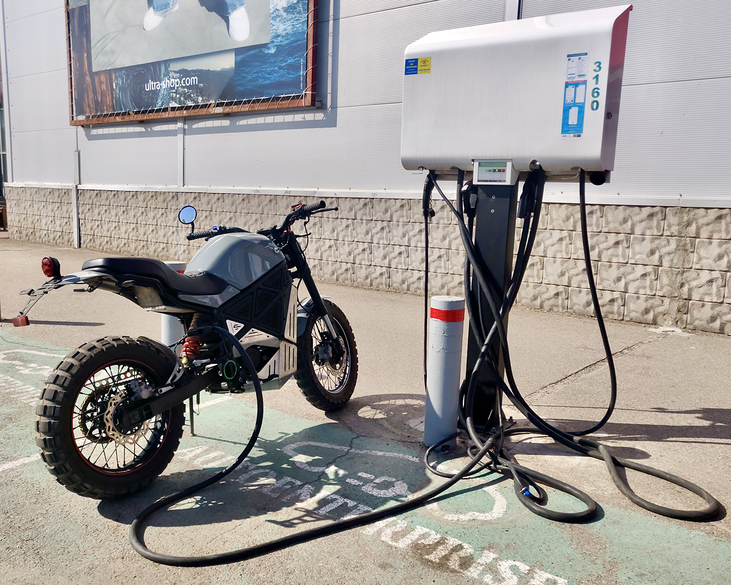 A back view of the ScrAmper - an electric motorcycle from Ukranian brand EMGo, capable of using an electric car charger