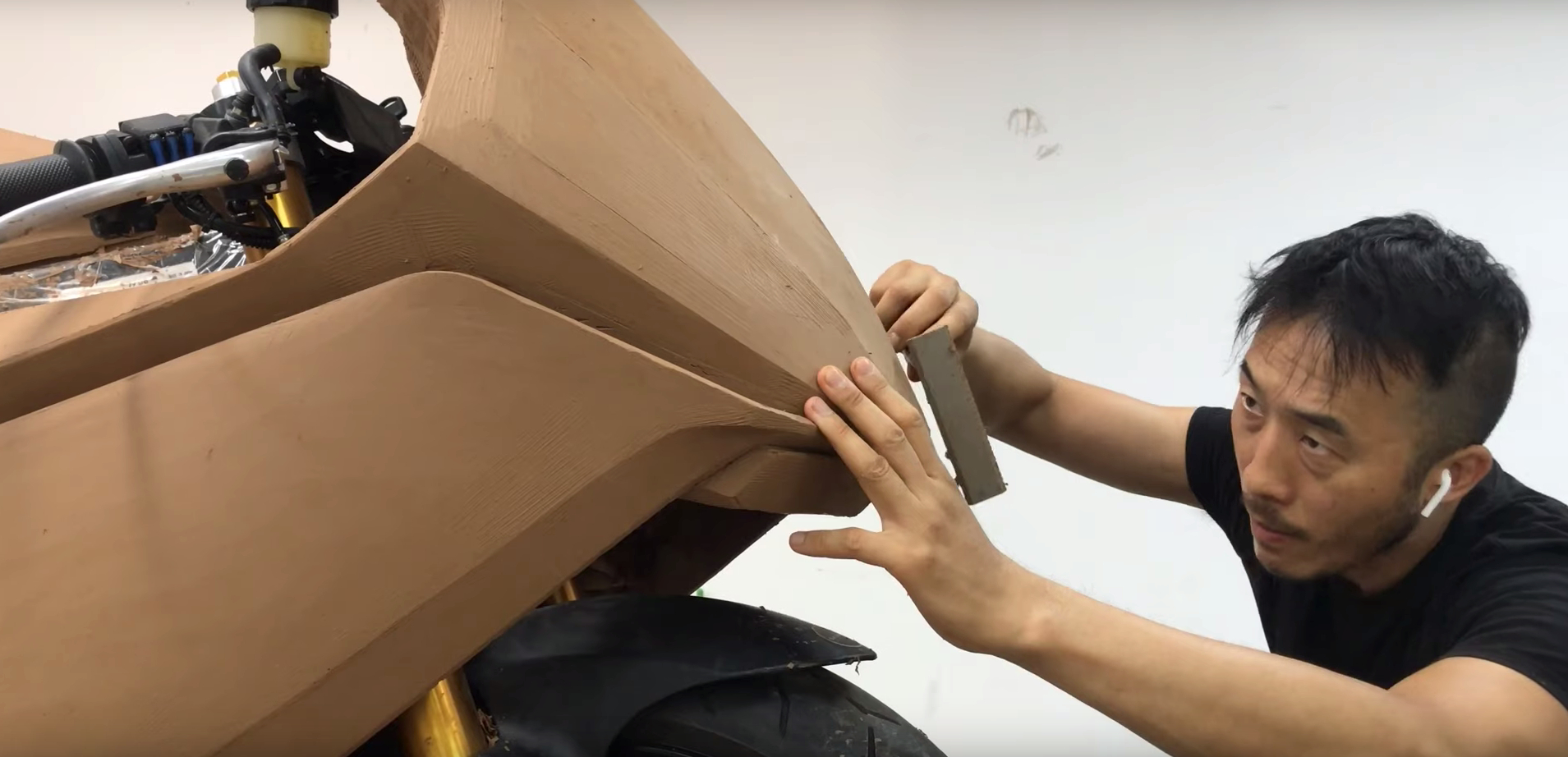 A view of a modeler at work on the creation process of a prototype motorcycle