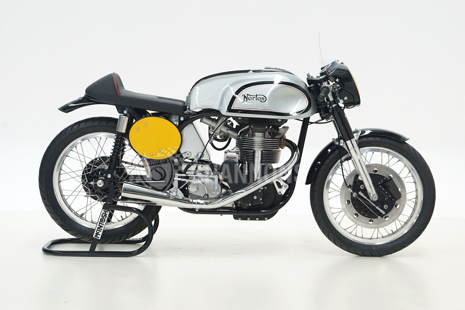 a studio shot of a 1950s Norton Manx motorcycle