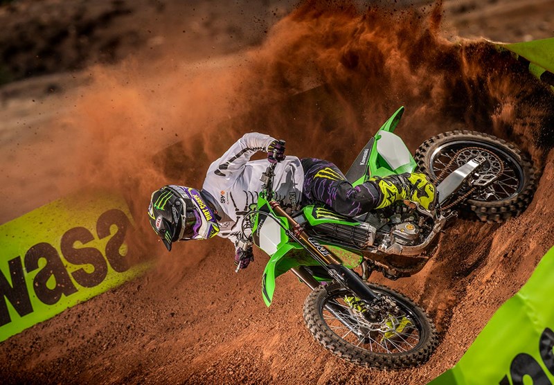 A side profile of a rider trying out the new 2022 Kawasaki KX450SR edition on a track